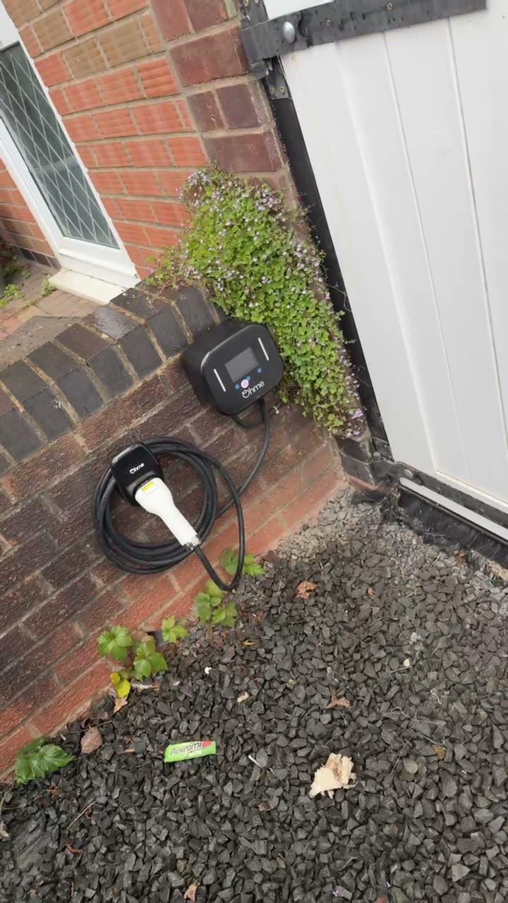 Ohme home EV charger installed on a brick wall with a tidy cable run