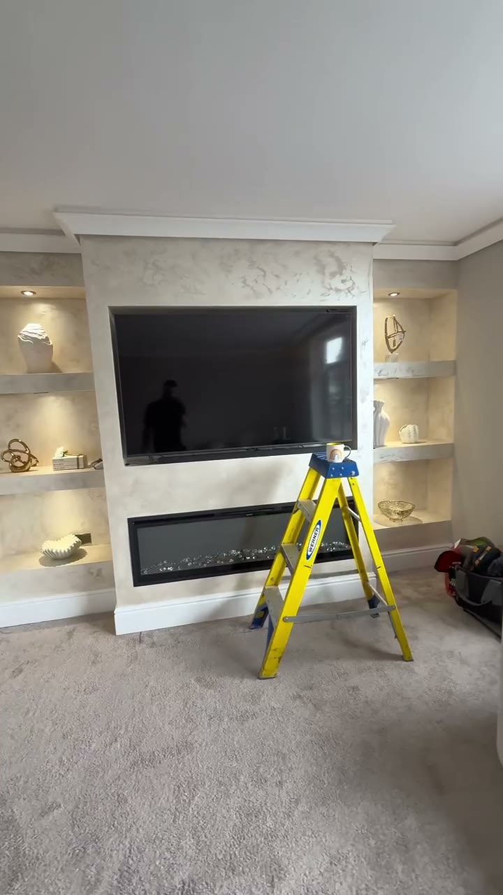 Feature media wall with concealed LED strip lighting and alcove downlights